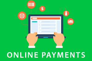 Hands below laptop making online payments